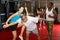 Woman learning knee strike during group self-defence training