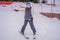 Woman learning to ski. Young woman skiing on a snowy road in the mountains