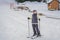 Woman learning to ski. Young woman skiing on a snowy road in the mountains