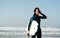 Woman leaving the with bodyboard after surfing