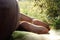 Woman legs barefoot on blanket on a picnic in a garden under war