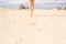 Woman legs barefoot walking in the desert