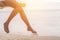 Woman legs at beach on wooden swing. Relax and Single woman concept. Happiness and lifestyle concept. Lonely and sadness concept.