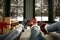 Woman legs in christmas socks on white blanket, snowy winter outside the big window background.