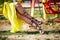 Woman legs in elegant high heel sandals sit on swing carousel in