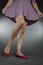 Woman legs and feet wearing purple dress