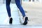 Woman legs with high heels stumbling in the street