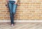 Woman legs in jeans and red sneakers