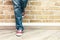 Woman legs in jeans and red sneakers