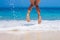 Woman legs, jumping on the beach