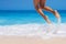 Woman legs, jumping on the beach