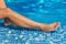 Woman legs near a swimming pool