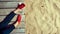 Woman legs in red boots on wooden pier near sandy beach.  Concept of relaxation, travel and serenity, lifestyle