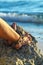 Woman legs with sandals on stone near tropical blue sea Philippines