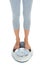 Woman, legs and scale in studio for weight loss, healthcare and wellness for vitality. Female person, diet and check