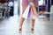 Woman legs, shopping bag and sale at a mall while holding paper bag for retail therapy, sale and customer discount. Feet