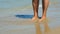 Woman legs standing on waterline