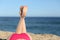 Woman legs sunbathing on the beach lying down