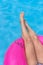 Woman legs sunbathing swimming pool