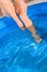 Woman legs in swimming pool blue water