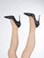 Woman with legs up and stiletto female shoes with high thin heels