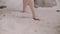 Woman legs walking on sand beach. Female feet on sand barefoot