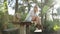 Woman leisurely sitting on a table in forest landscape