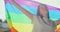 Woman lesbian holds a LGBT gender identity flag on a background. Smiled young woman spinning around with lgbt flag on