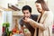 Woman letting man taste a soup