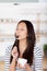 Woman licking a coffee spoon