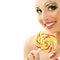 Woman licks candy with beautiful make-up