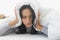 Woman lie prone and put blanket cover head
