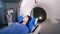 A woman lies on a moving cot of a CT machine.