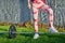 woman lifting a gym weight bar in an outdoor park. Un recognizable face