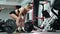 Woman lifts a barbell in the gym, fitness woman doing strength exercises.