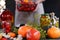 Woman in linen apron with hands holding bowl of homemade fresh vegetables. Food preservation during coronavirus crisis. Tomatoes,