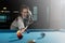 Woman Lining To Hit Ball On Pool Table