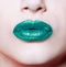 Woman lips with glossy green lipstick