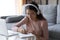 Woman listen audio course through headphones makes notes in copybook