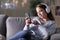 Woman listening to music using headphones and phone