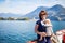 Woman with little girl enjoying scenic view Lugano from the lake