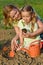 Woman and little girl growing healthy food