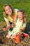 Woman and little girl planting tomato seedlings