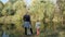 A woman with a little girl standing on the Bank of the river on a Sunny autumn day looking into the distance. The view