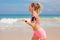 Woman living active lifestyle, running on the beach