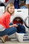 Woman Loading Clothes Into Washing Machine