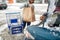 Woman loading food from shopping cart to car trunk