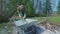 Woman loading out rubbish from wheelbarrow