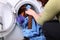 Woman loading the washing machine in bathroom