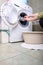 Woman loading the washing machine in bathroom